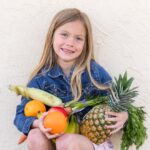 Girl holding fresh produce